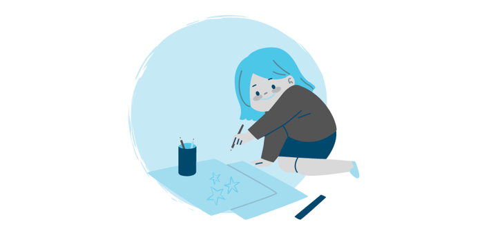 girl grinning and drawing stars on a piece of paper