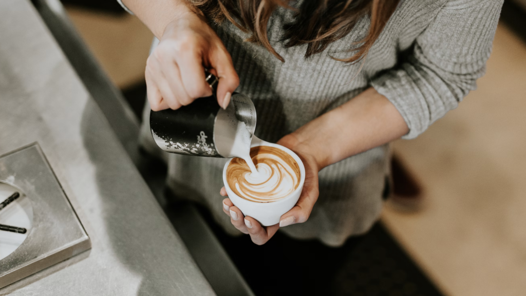 a figure pouring latte art 