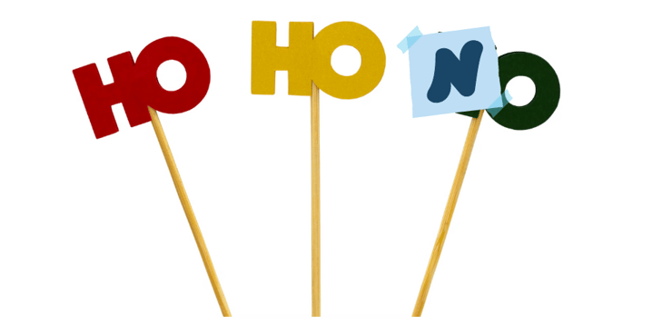 christmas decorations that spell out ho ho ho. The last word has had a sticky note placed over it so that it now reads ho ho no.