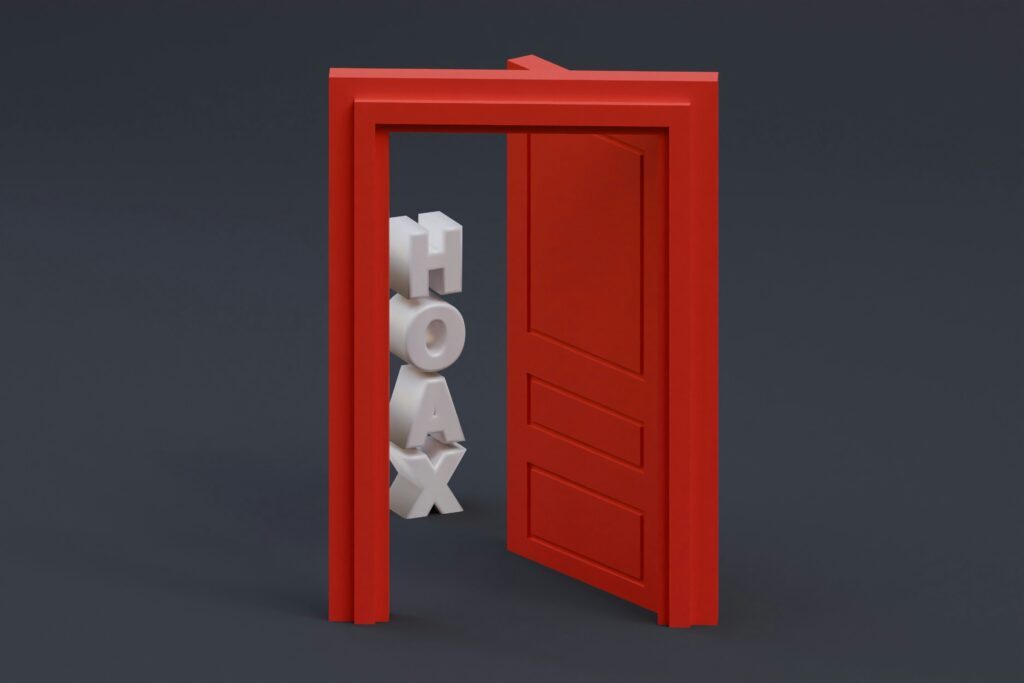 The word 'Hoax' in 3D letters about to move through the frame of an open door. 